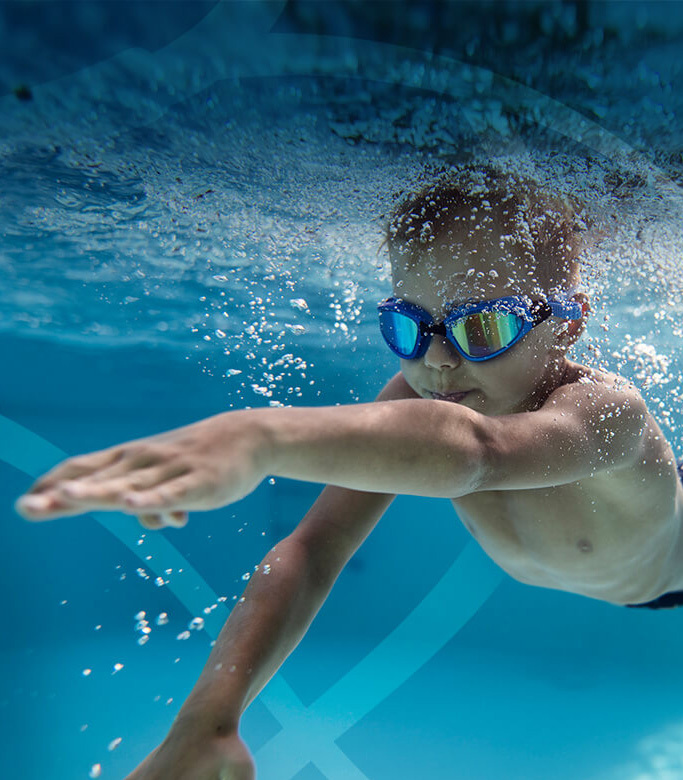 Photo of boy swimming forward: we are working to make a difference for patients with rare endocrine diseases and cancer